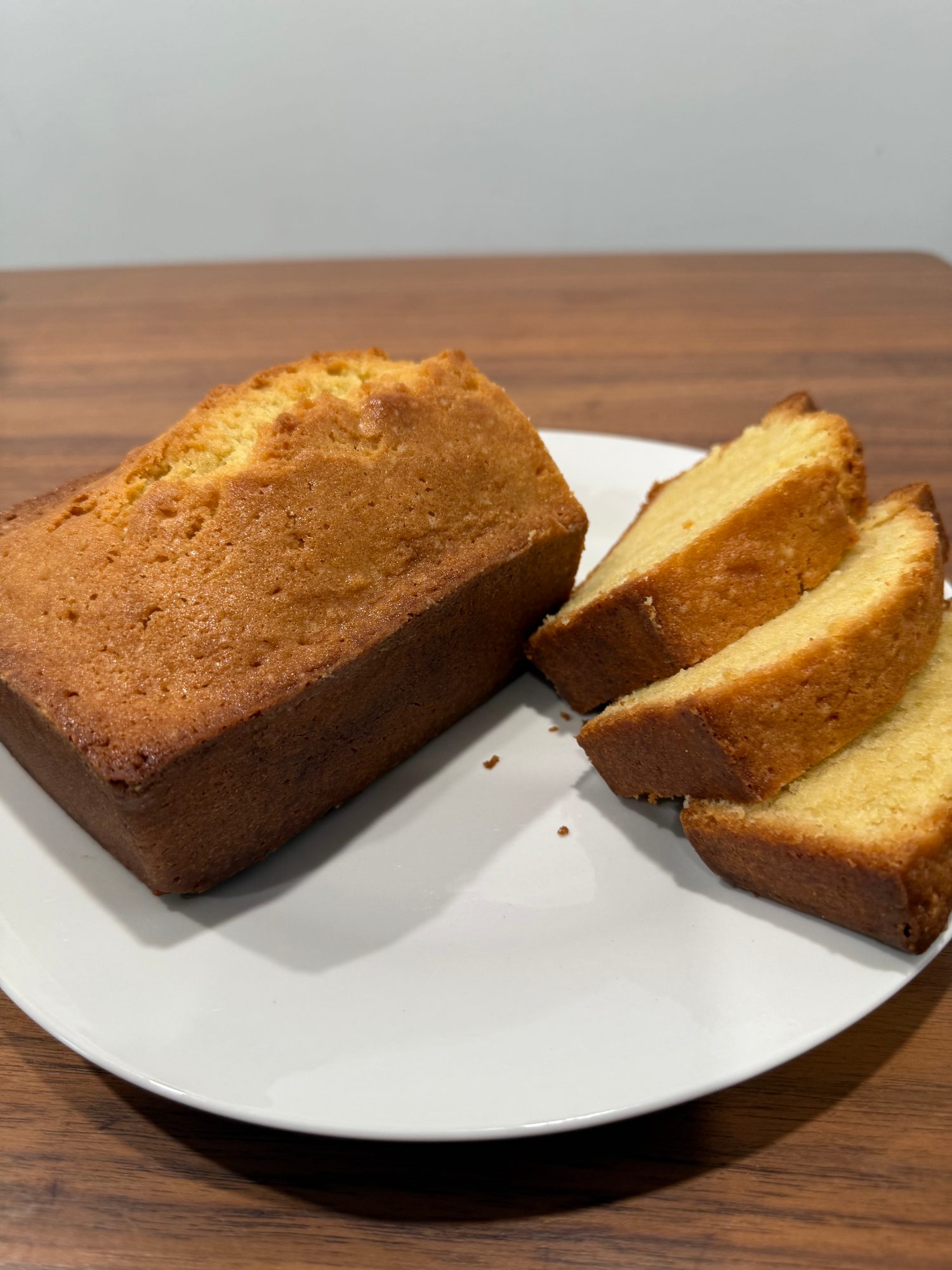 Quatre-quarts loaf and sliced pieces on a plate